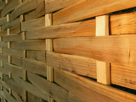 A close-up of a wooden chestnut panel lath, showing the texture and weave of the material.