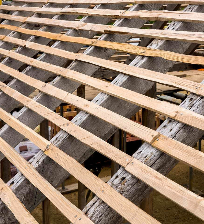 close up of 4ft hand cleft chestnut battens laying on roof joists