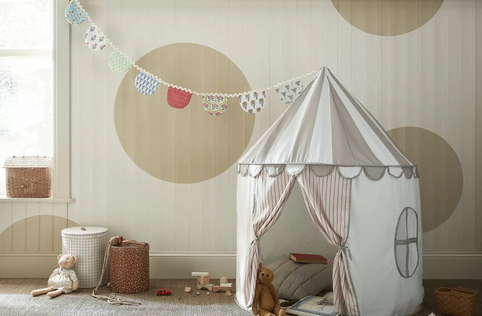 Children's play tent in a room with toys and decorative elements