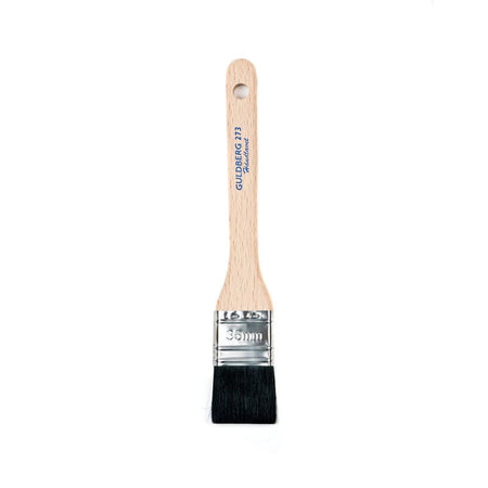 Paint brush with wooden handle and metal ferrule on a white background