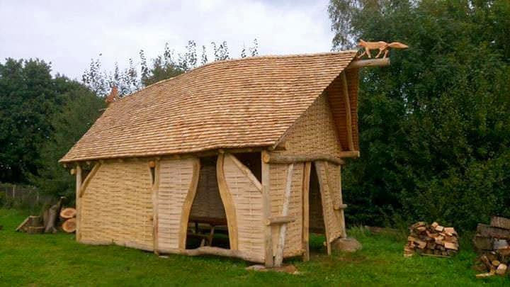 A rustic, handcrafted chestnut shake roof covering a structure, with varying shake widths and a natural tannin-rich appearance.