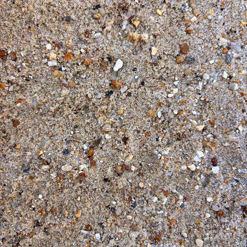 Close-up of sand with small stones and pebbles