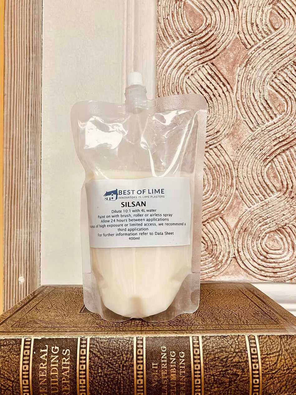 A pouch of Silsan FC624 treatment for masonry and stone, displayed against a patterned background.