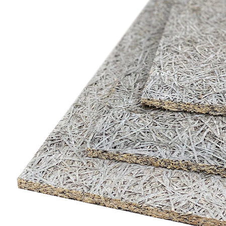 Stack of grey wood wool boards showing the texture and thickness of the material.