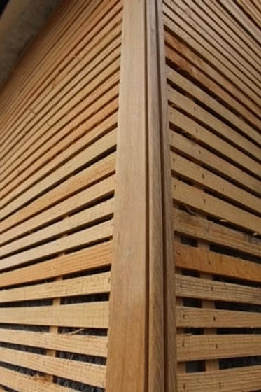 Close-up of a sawn wooden lath with a slightly raised grain texture.