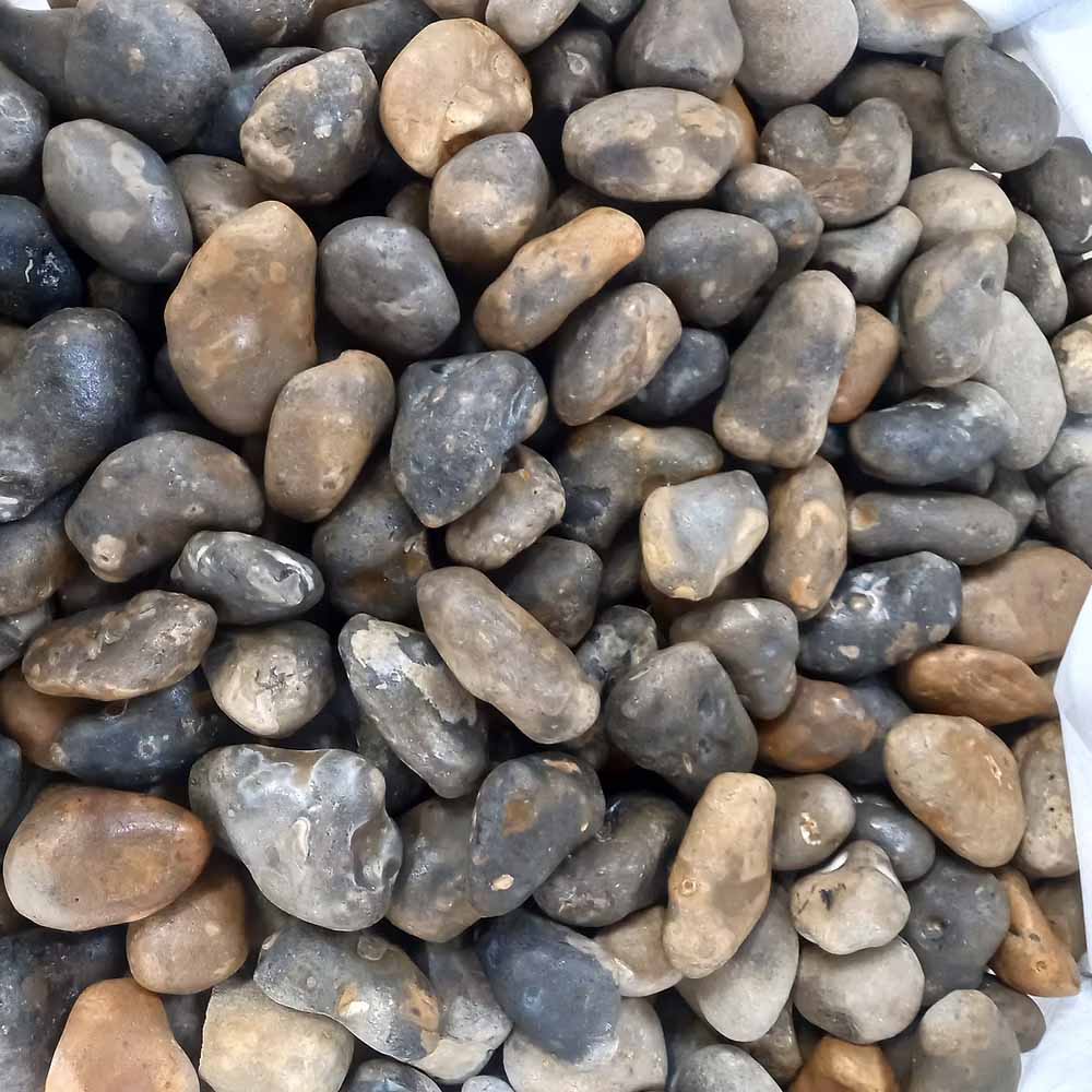 close up of smooth cobbles in a bulk bag