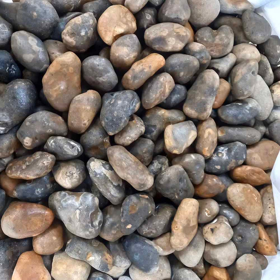 close up of smooth cobbles in a bulk bag