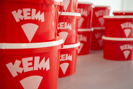 Red buckets with 'KEIM' branding on a white background