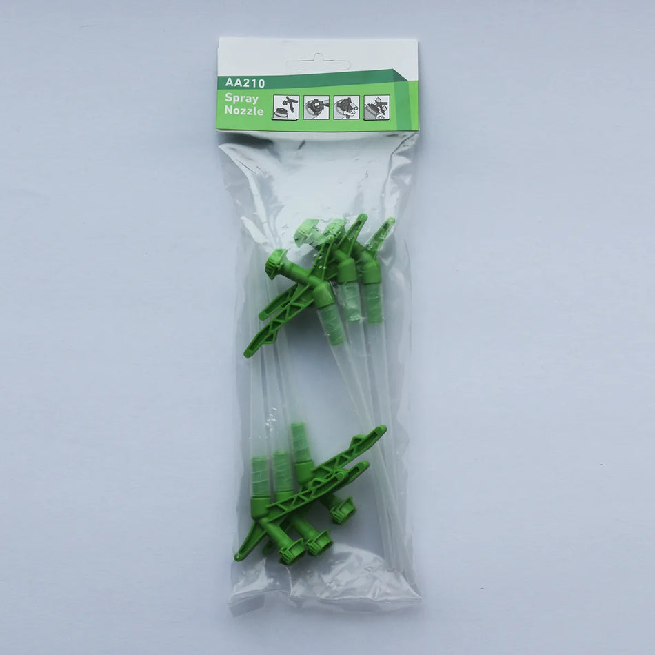 Packaged green spray nozzles with a clear plastic bag on a white background