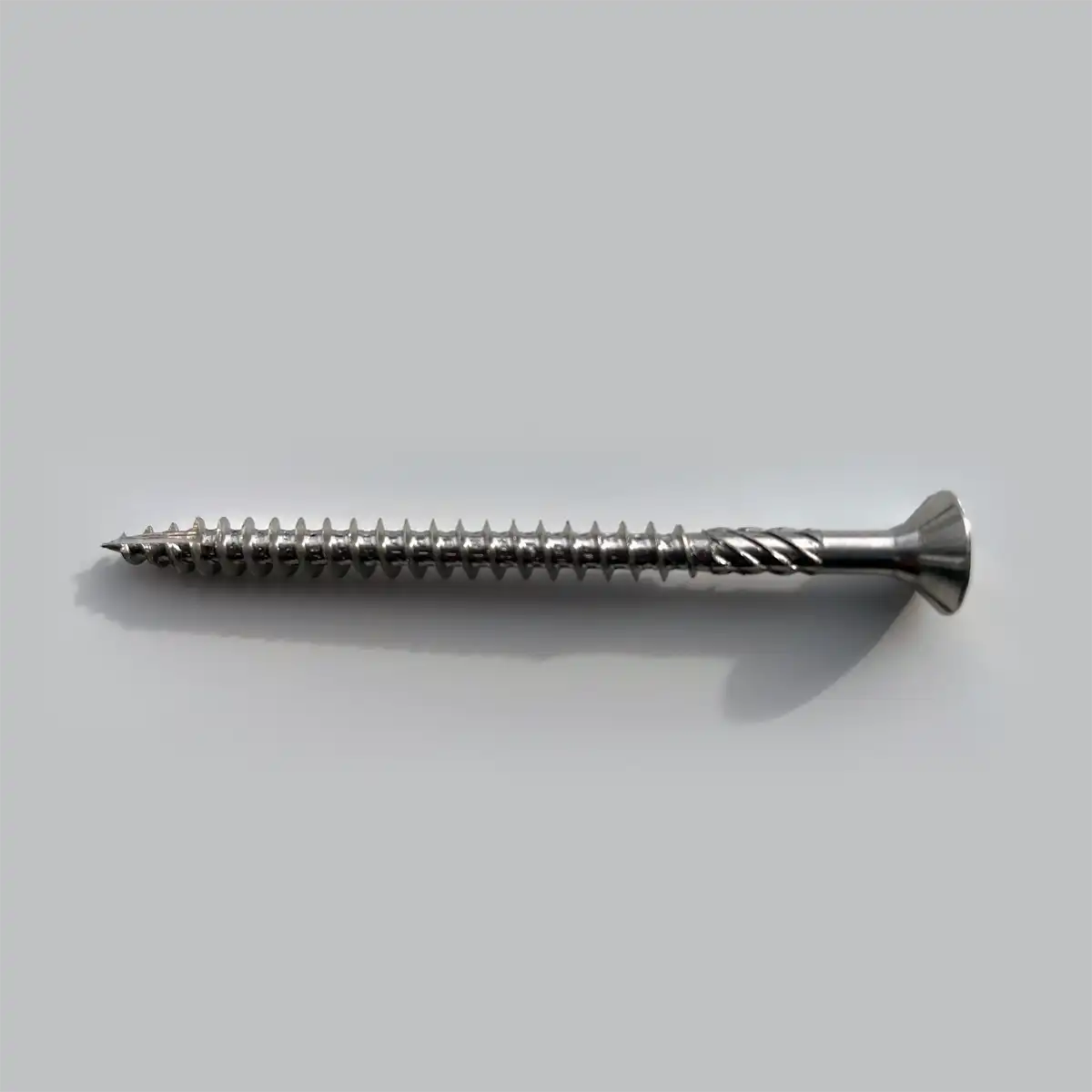 Metal screw on a light gray background